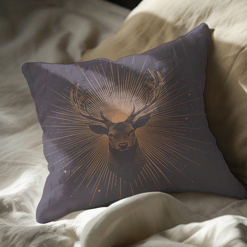 A pillow cover showing a noble stag rendered in shimmering beige against navy blue fabric. Fine beige tan rays extend from the deer's head like sunbeams, with scattered stars.